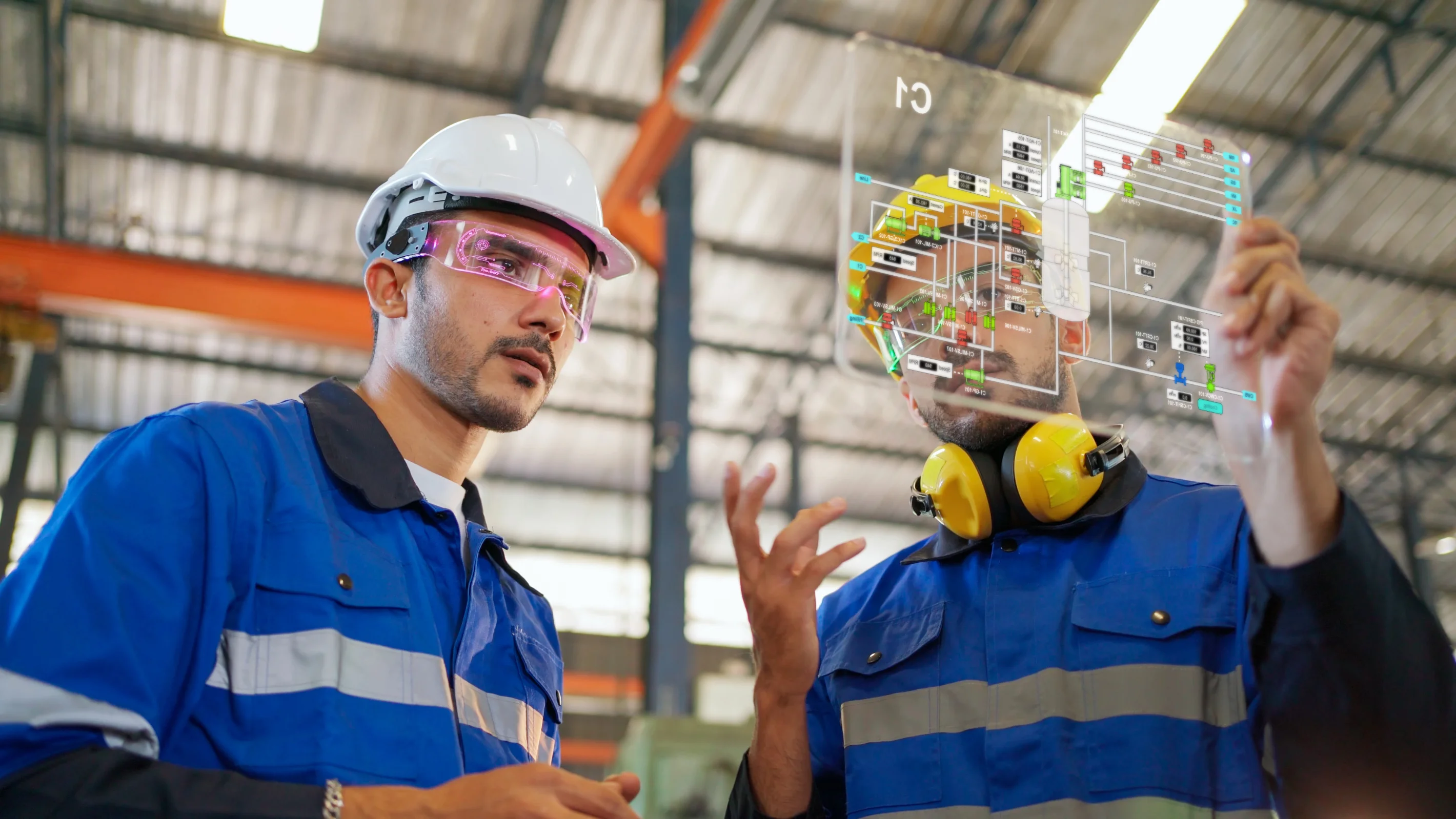 Two technicians reviewing AI-assisted diagnostics on a digital display in a factory